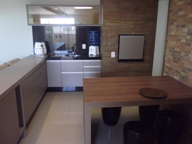 Espaço com Churrasqueira, pia e mesa integrada com a Sala.